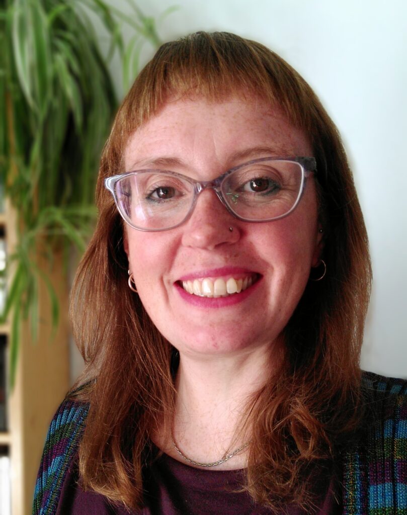 Bethan Prosser (photo by Paul Stapleton): close up portrait photo of woman with glasses smiling